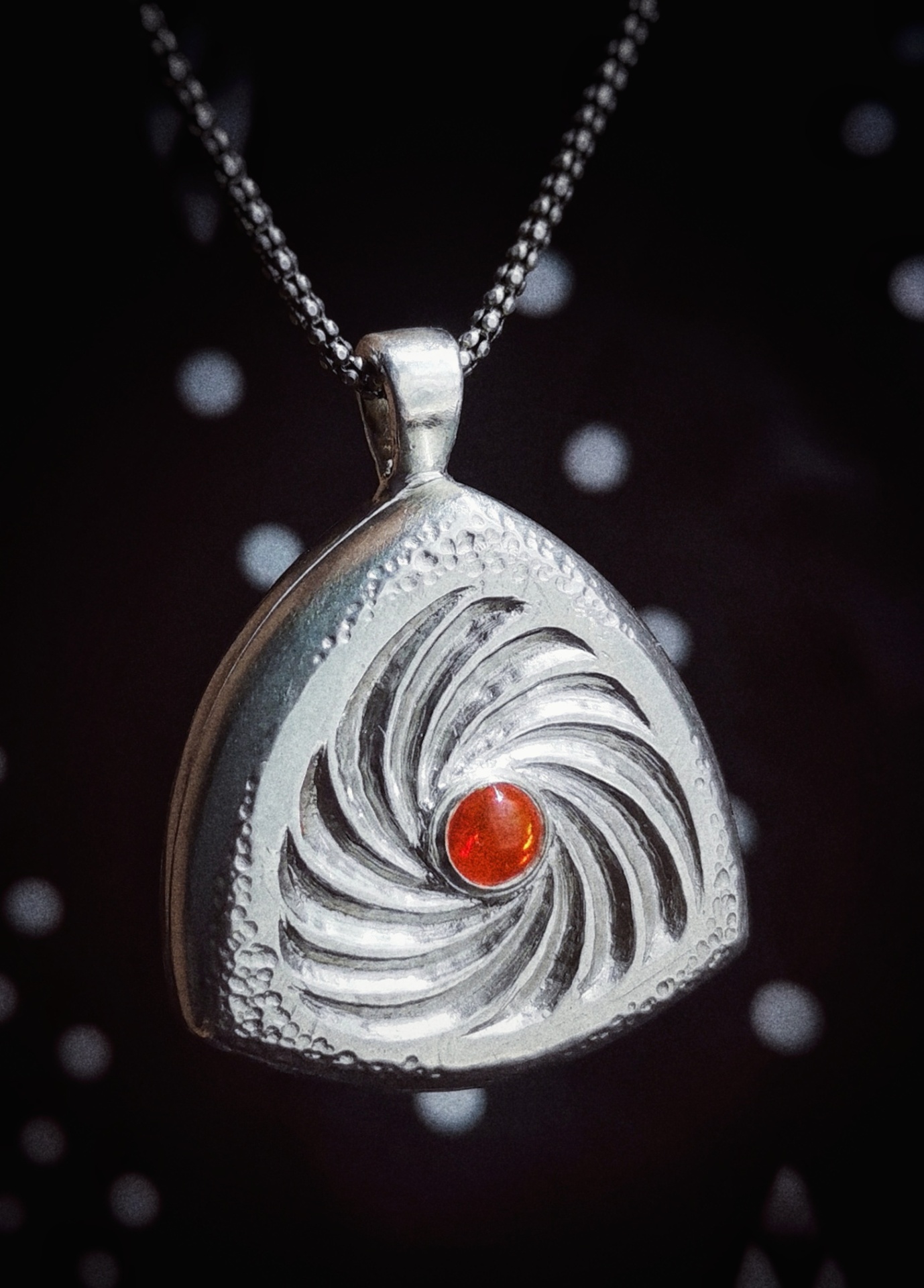 Silver swirl pendant with fire opal centre