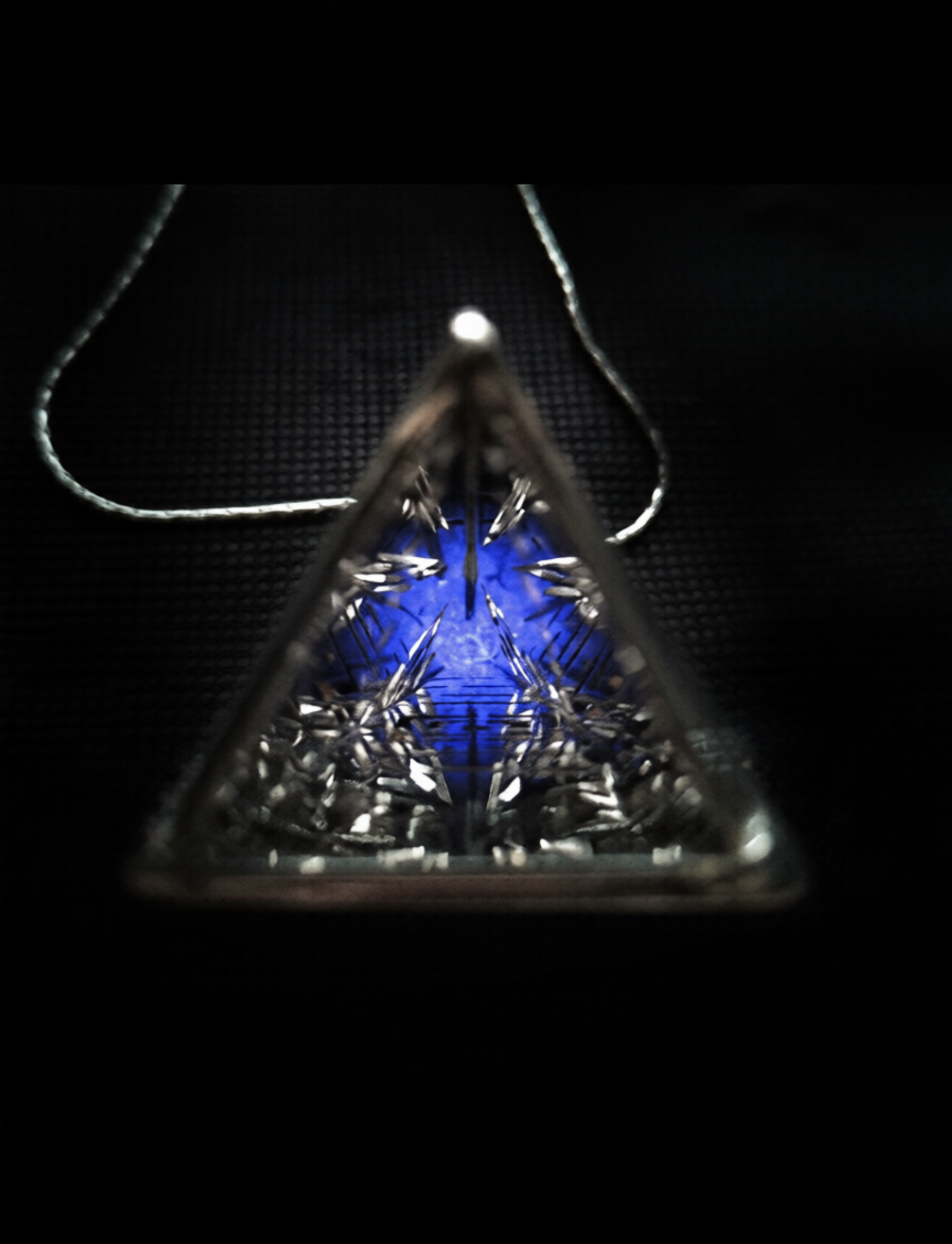 Triangular pendant with cut blue stone