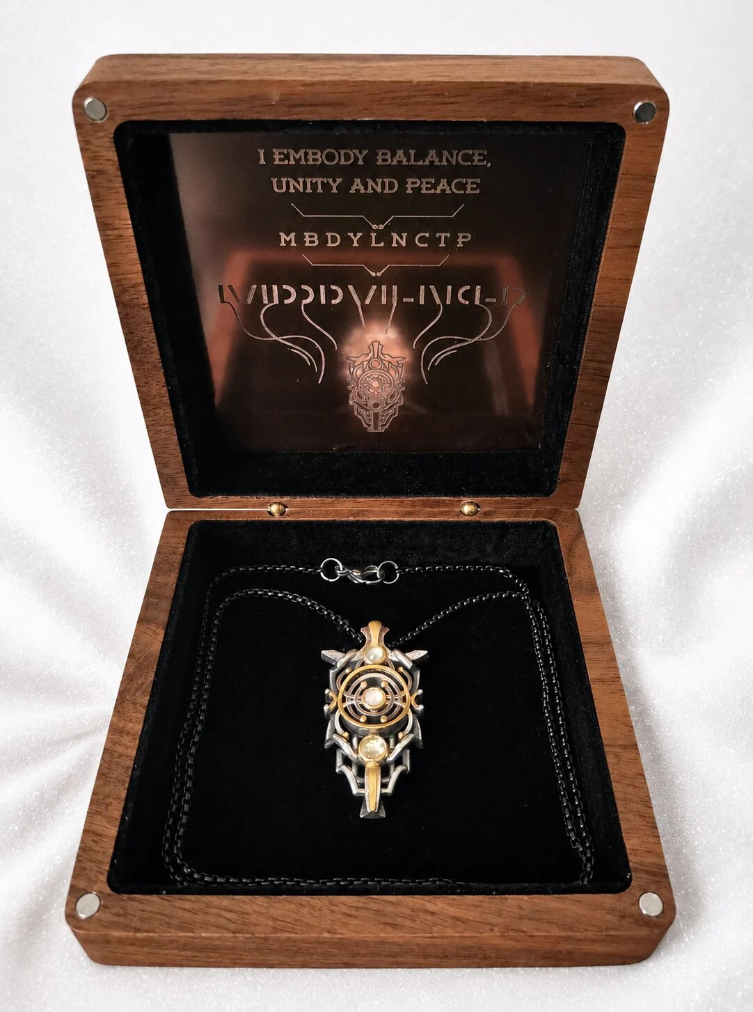 The Harmoniser pendant in its engraved presentation box